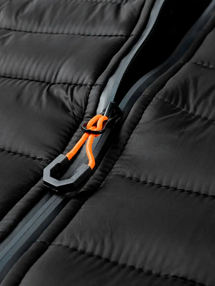 Women's black puffer jacket with hood, a chic and warm essential for the winter season.