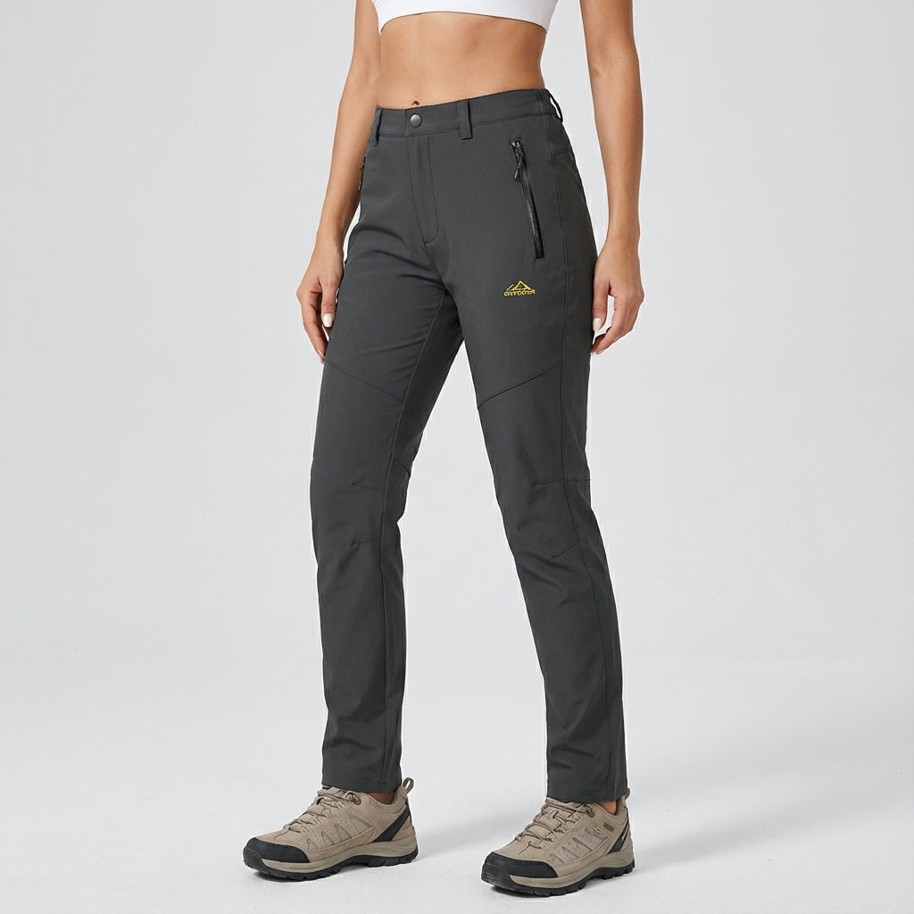 Close-up of women's fleece-lined waterproof hiking pants, showing durable fabric & warmth for outdoors