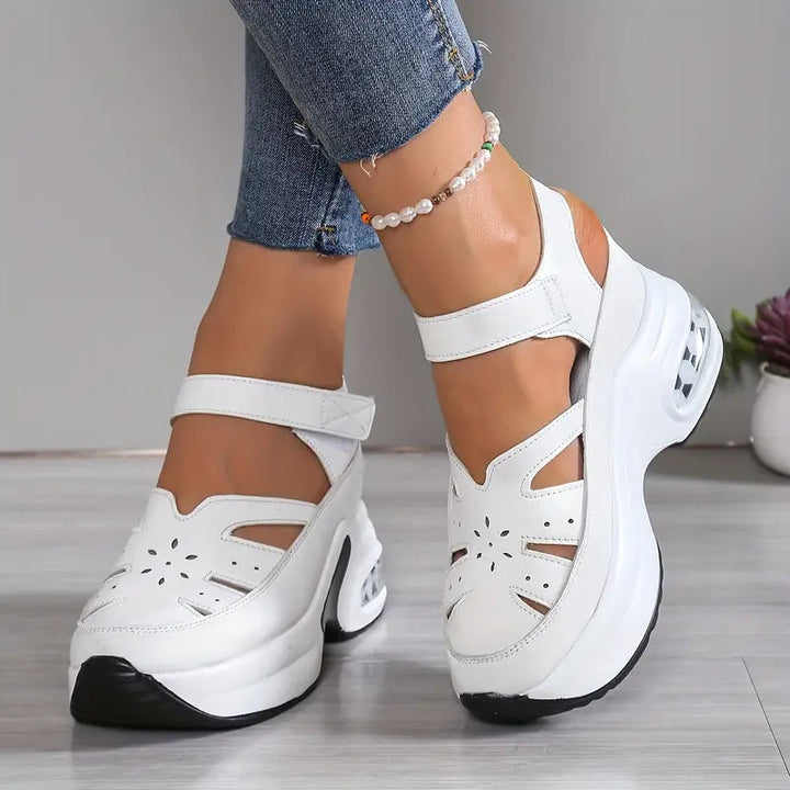 Stylish cutout wedge sandals for women, offering a cushioned platform and breathable comfort for all-day wear.