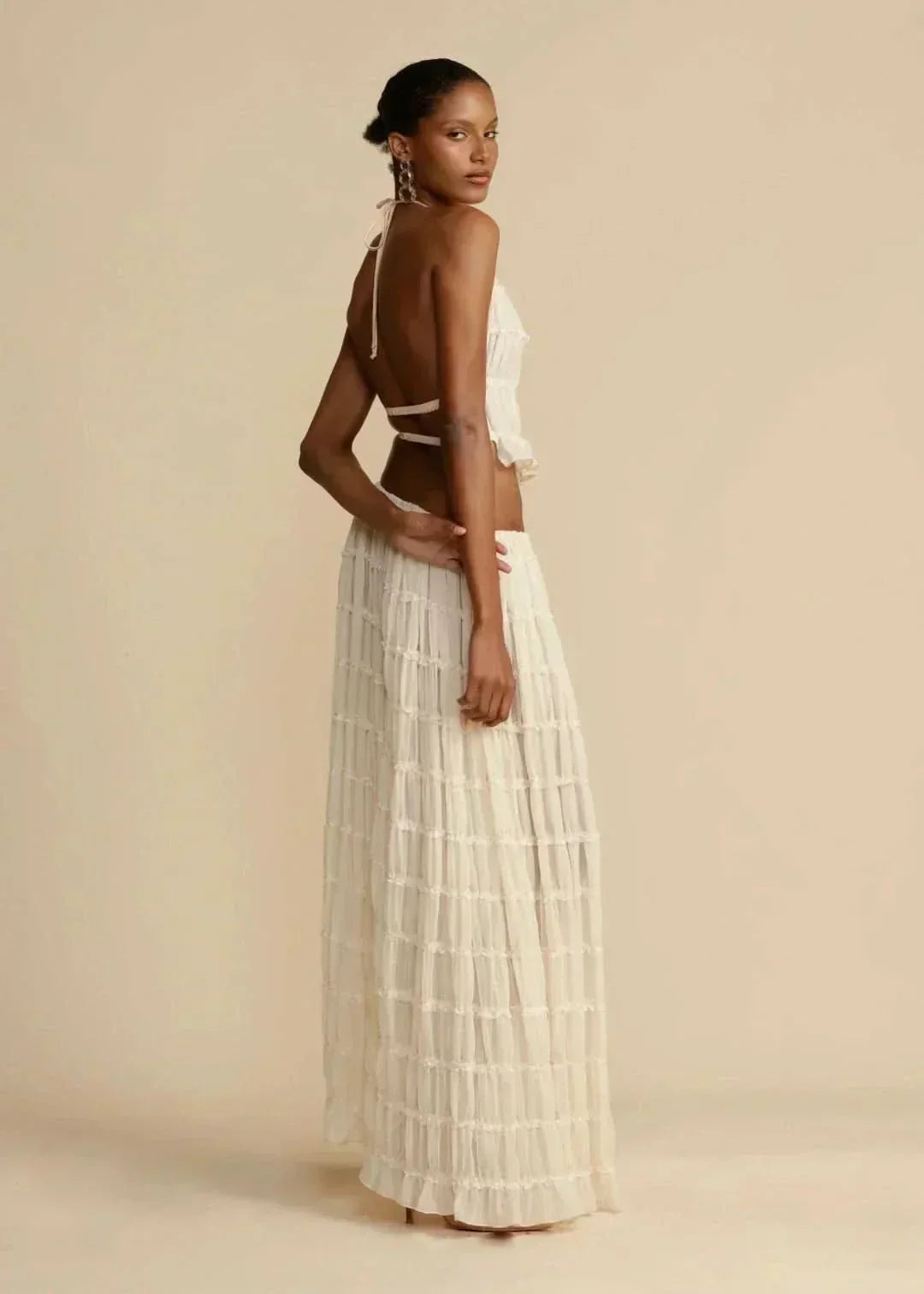 Bohemian women's white two-piece set featuring an off-shoulder top and flowy maxi skirt
