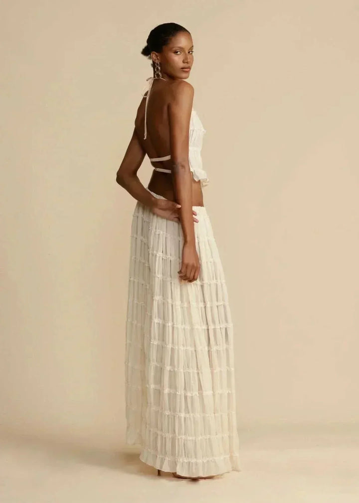 Bohemian women's white two-piece set featuring an off-shoulder top and flowy maxi skirt