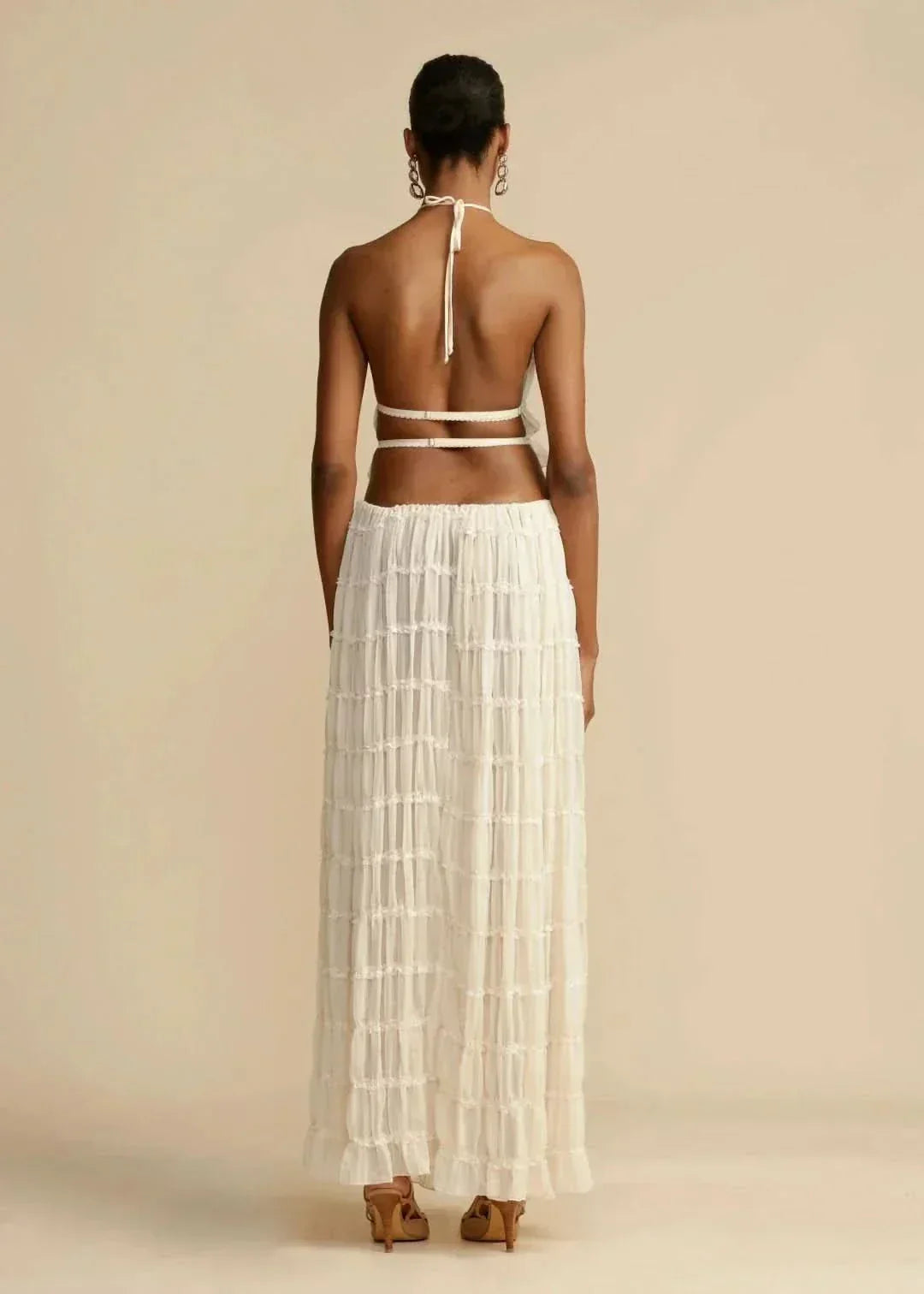 Elegant women's white boho two-piece set with an off-shoulder crop top and a long maxi skirt