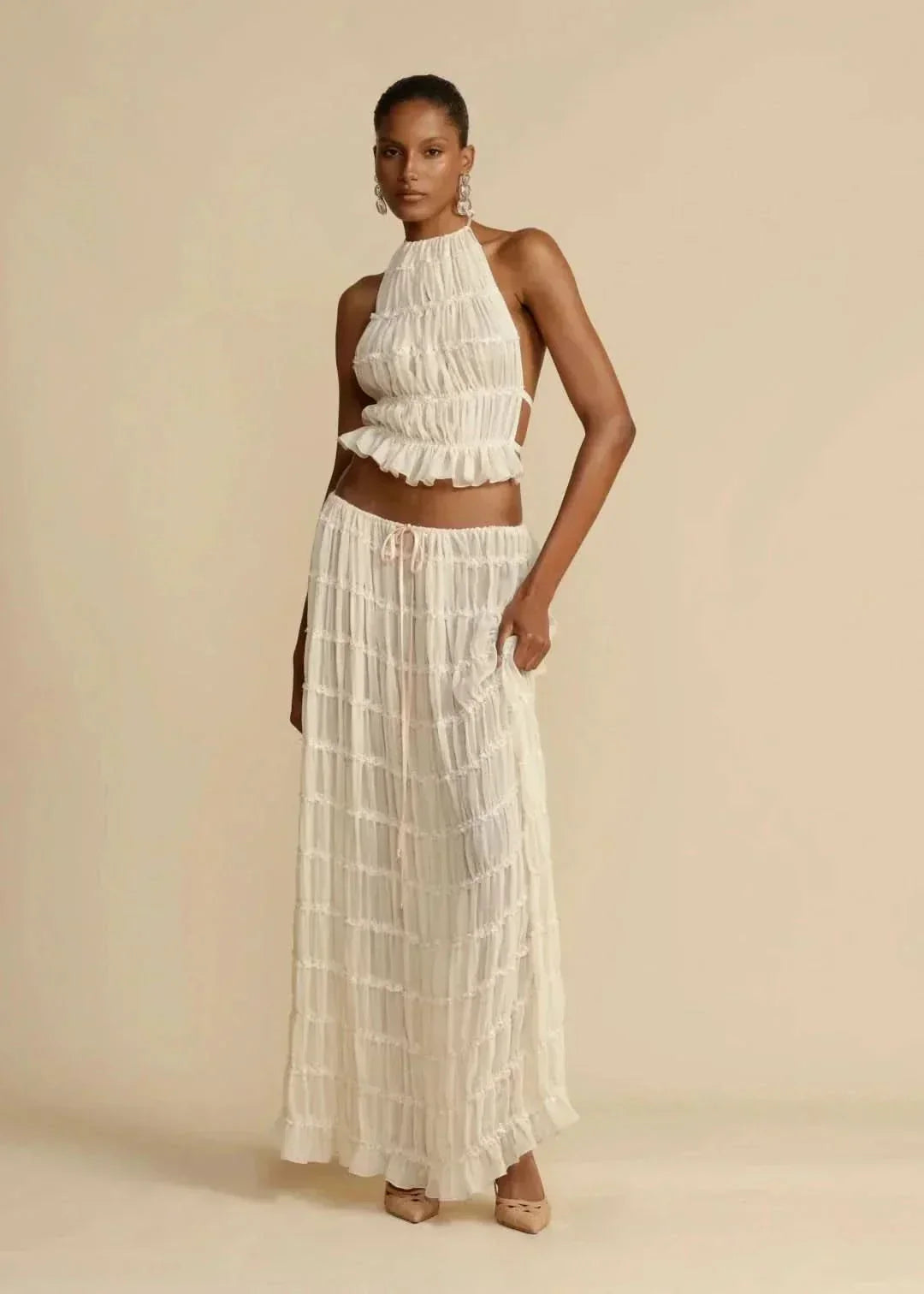 Bohemian white summer outfit: women's off-shoulder crop top and matching maxi skirt, beach ready