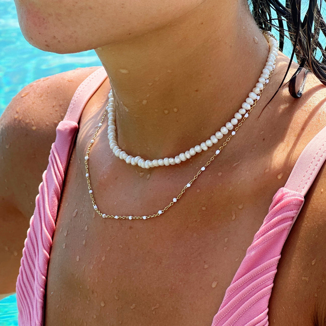 Aurielle white enamel bead choker necklace for women. Stylish and delicate accessory.