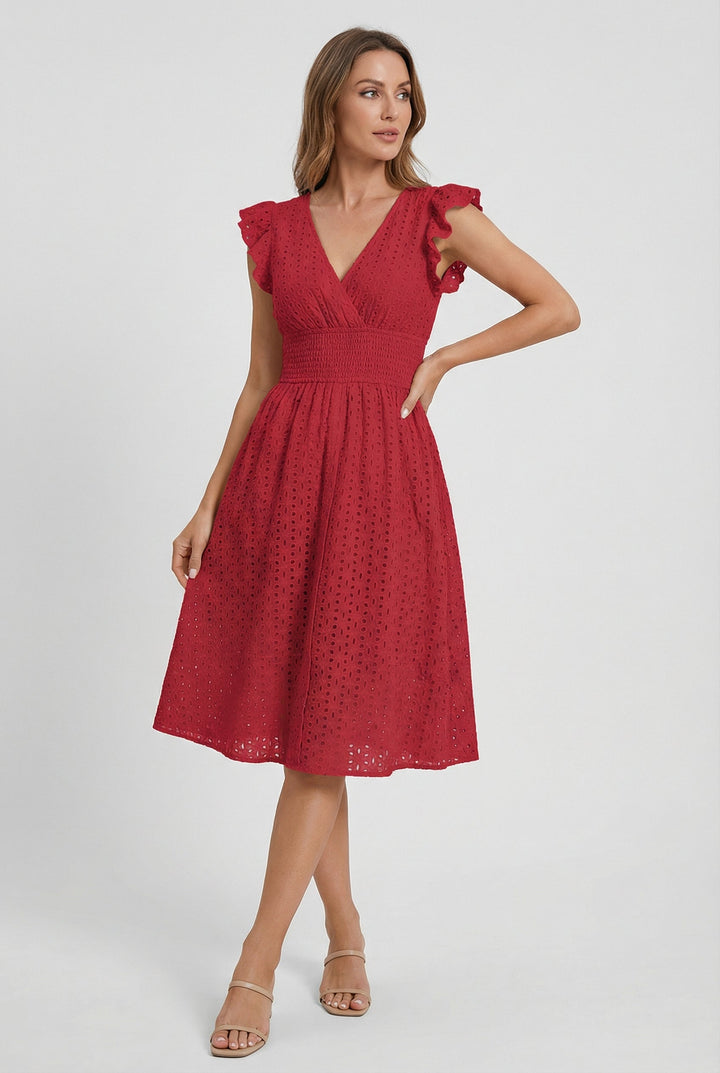 White eyelet summer midi dress for women, featuring a comfortable smocked waist and ruffles.
