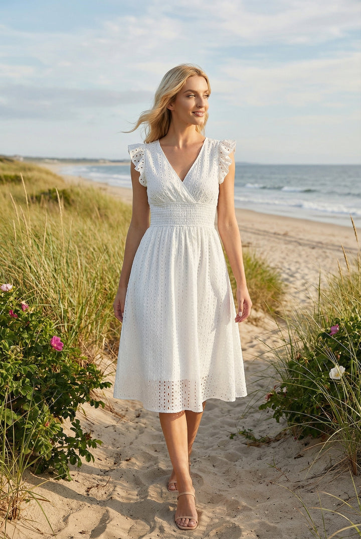 Casual women's eyelet dress with ruffled sleeves, ideal for beach or vacation style.