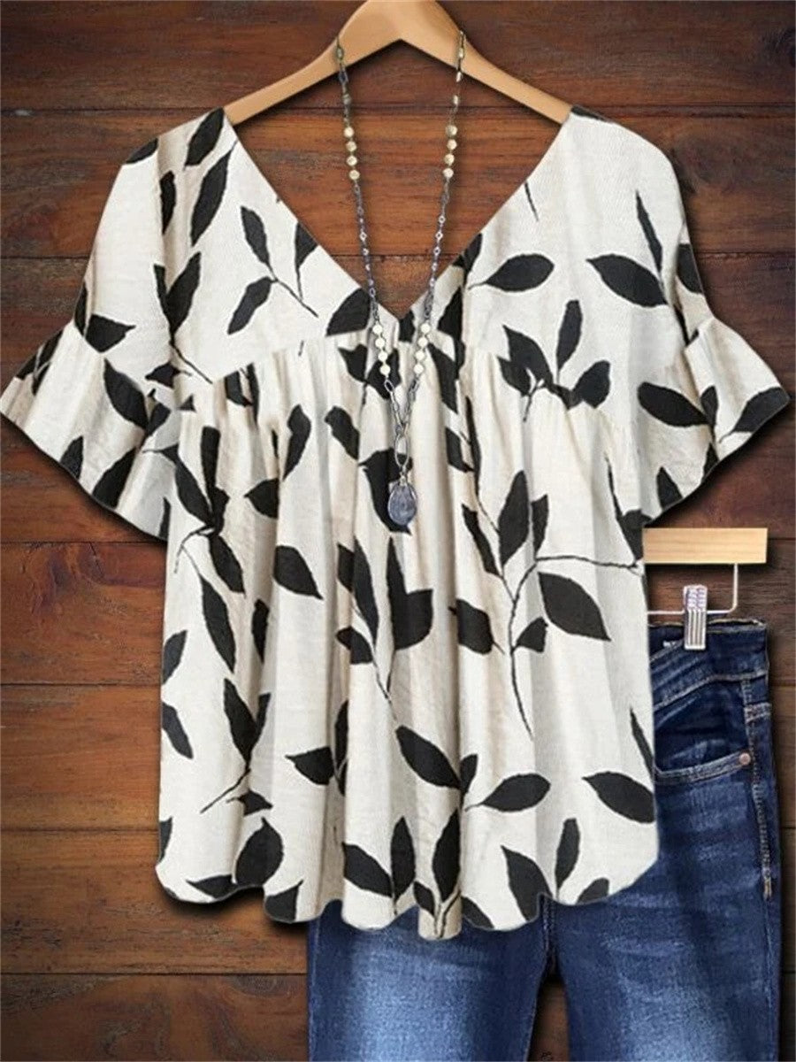 Women's white leaf print V-neck smock blouse with ruffle sleeves, perfect for summer casual & boho style.