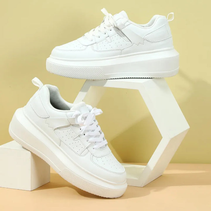 Women's white perforated platform lace-up sneakers, ideal for casual summer fashion.