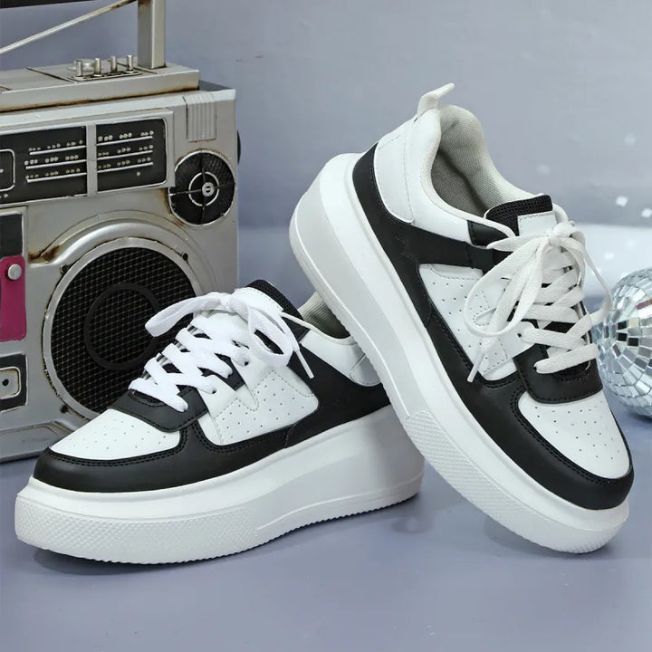 Black perforated women's platform lace-up sneakers, offering trendy & comfortable footwear.