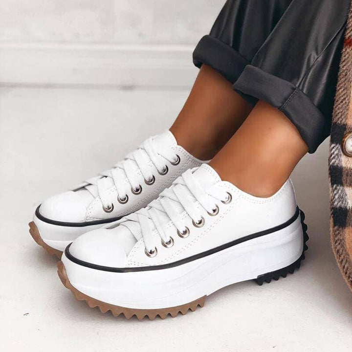Stylish women's platform sneakers in a clean white finish, designed to elevate your everyday fashion effortlessly.