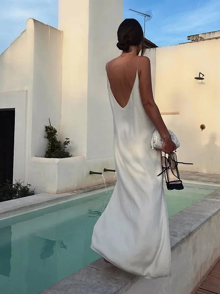 Women's white V-neck ankle-length stretch maxi dress, ideal for everyday style and casual elegance. Flowy silhouette.