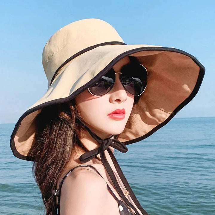 Women's wide brim foldable sun hat, Livia, offering UV protection, perfect for beach or travel