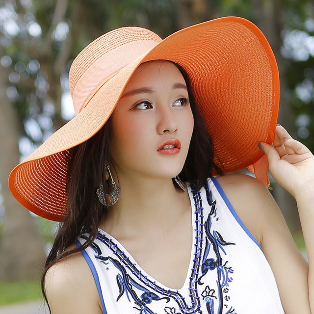Summer essential: pink wide brim straw hat for women, offering sun protection and style