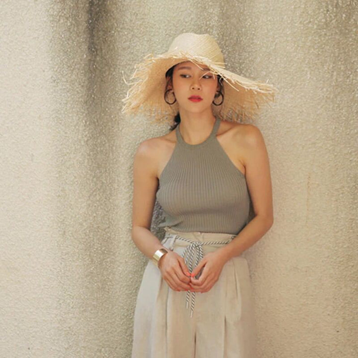 Elegant women's wide brim straw hat, perfect for sun protection & travel beachwear