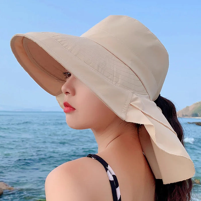 Fashionable women's wide brim sun hat with UV protection, foldable for easy travel, great for beach & outdoor adventures.