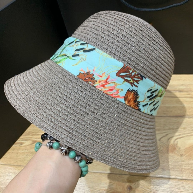 Stylish women's sun hat, wide brim with ribbon bow, offering UV protection.