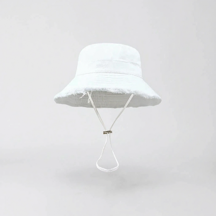 Solid color women's wide brim bucket hat. Adjustable for a perfect fit, ideal for beach and outdoor wear.
