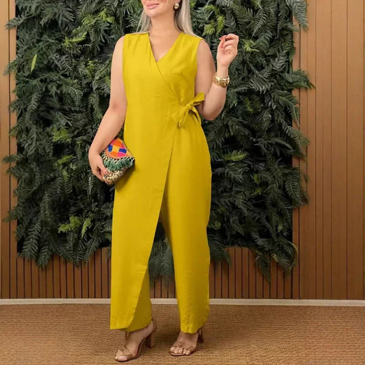 Sleeveless women's wide-leg jumpsuit, featuring a wrap V-neckline and tie waist belt for a chic, versatile outfit.