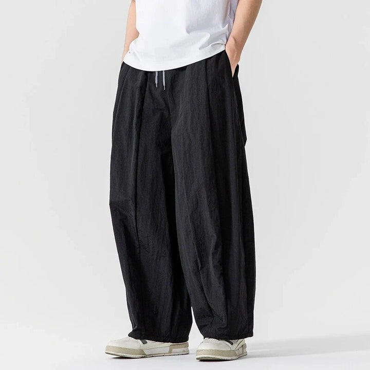 Flowy women's wide leg linen blend trousers with elastic waist & deep pockets, ideal for travel & vacation.