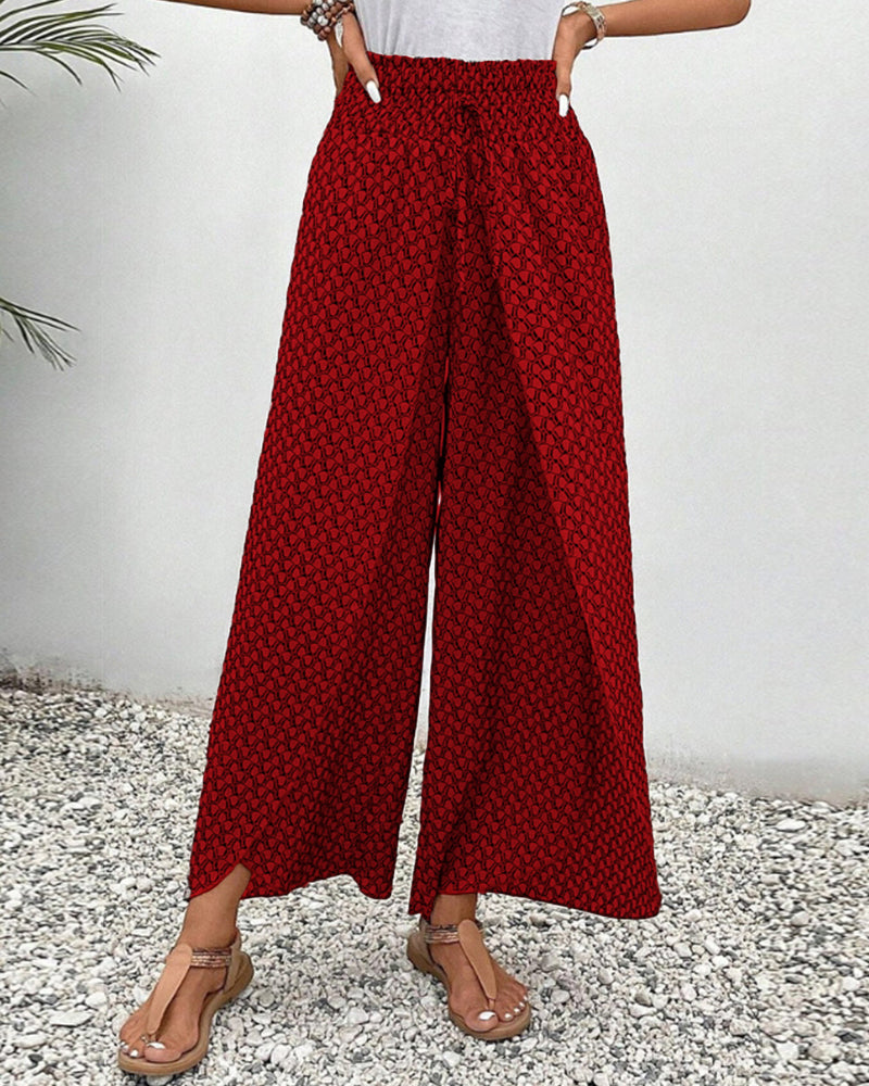 Full view of women's relaxed fit wide leg trousers in a vibrant geometric print. Day-to-night versatile.