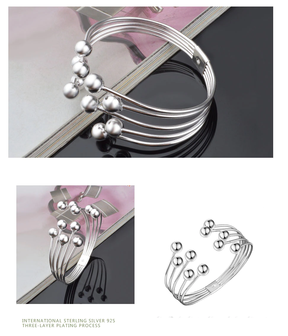 Close-up of a women's wide pearl bracelet, showcasing freshwater pearls & shining 925 sterling silver.