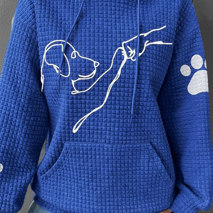Stylish woman wearing a cozy dog print 'Wilma' hoodie, ideal for winter apparel