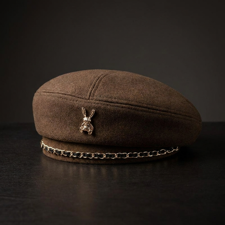 Elegant women's fashion baseball cap, wool blend, with a prominent sculptural bee emblem & delicate gold chain.