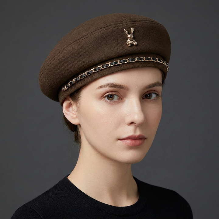 Statement women's baseball cap, premium wool blend, showcasing a sculptural gold bee emblem & chic chain accent.