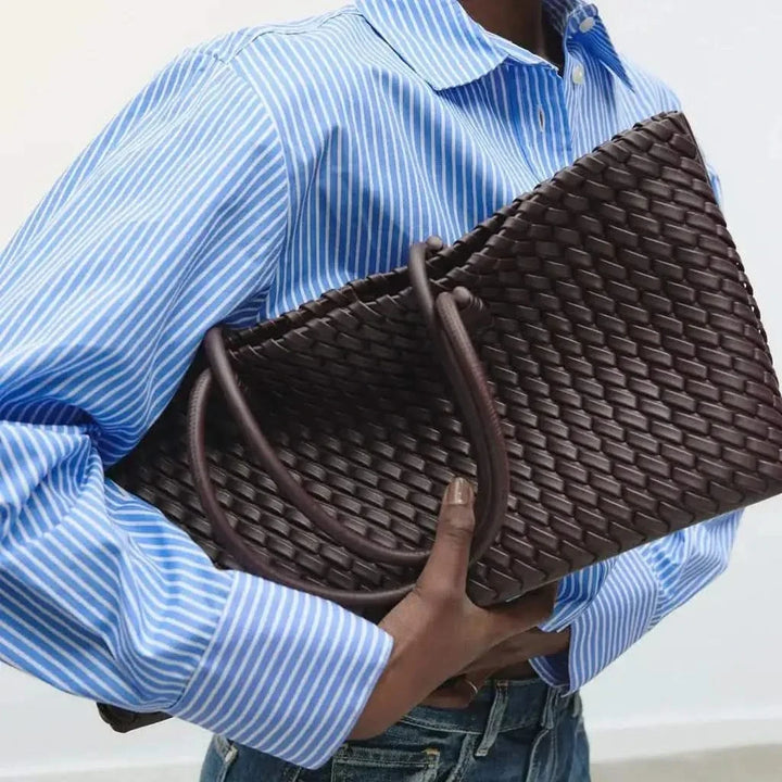 Hand-woven detail on a luxurious women's leather handbag, featuring exquisite texture.