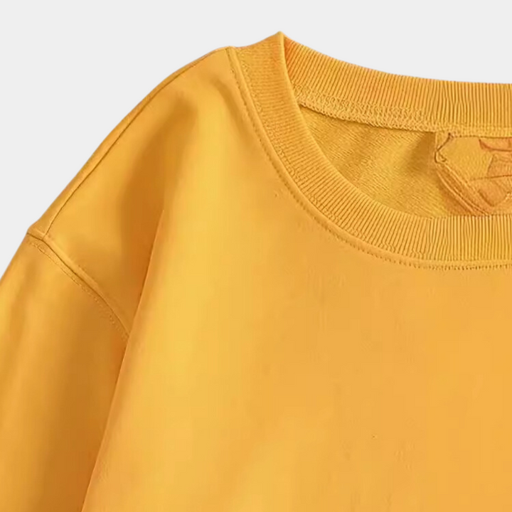 Soft yellow women's sweatshirt featuring an elegant floral pattern, great for everyday casual comfort.