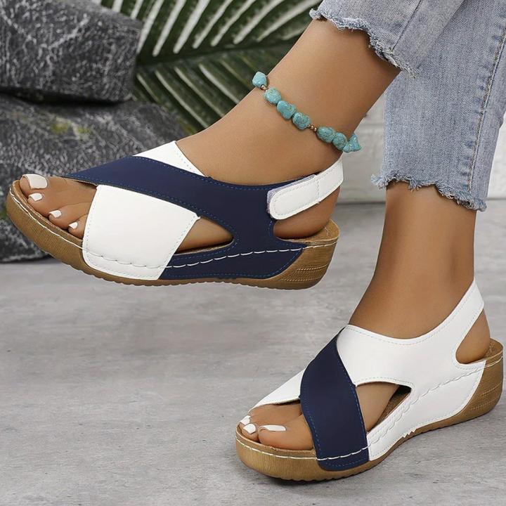 Stylish Yola women's flat sandals in a classic color, providing comfortable and chic everyday wear.