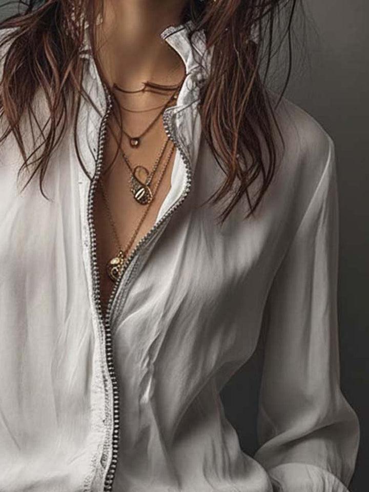 Chic women's top: zip-front design, long bell cuffs, offering a stylish and versatile look.