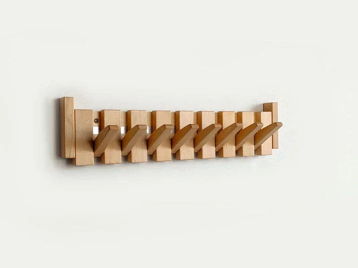 Detailed view of a unique wooden coat rack, shaped like piano keys, enhancing home entryway
