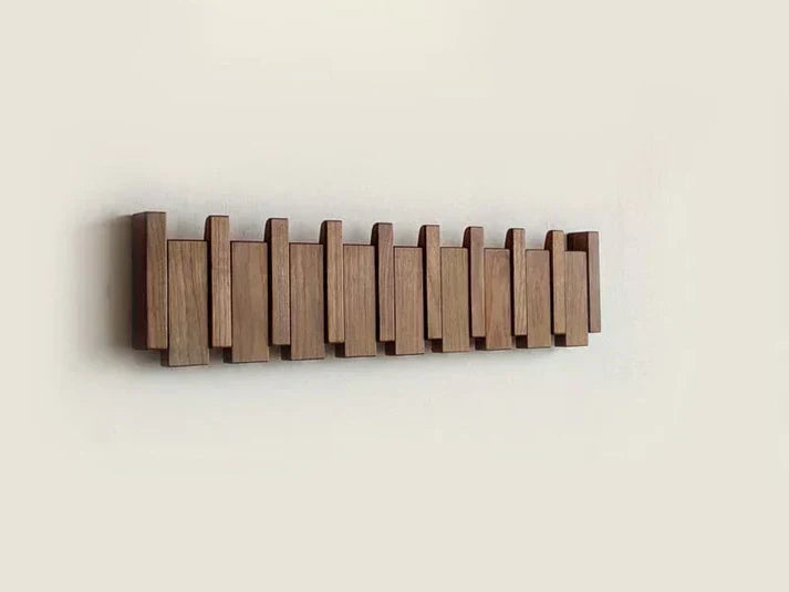 Modern home decor: wooden piano key coat rack installed, showcasing practicality and design