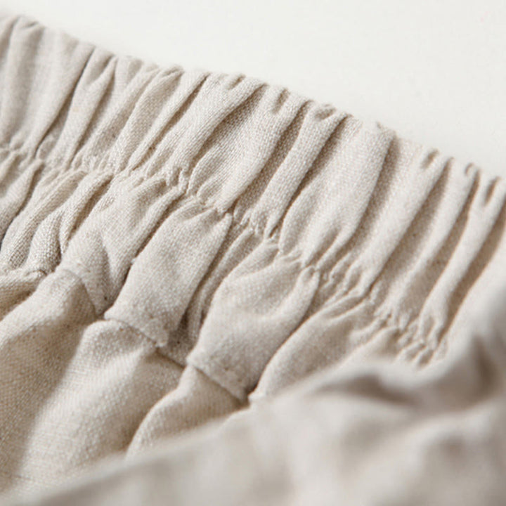 Beige women's high-waisted wide-leg pants, relaxed fit ideal for casual, comfortable fashion.