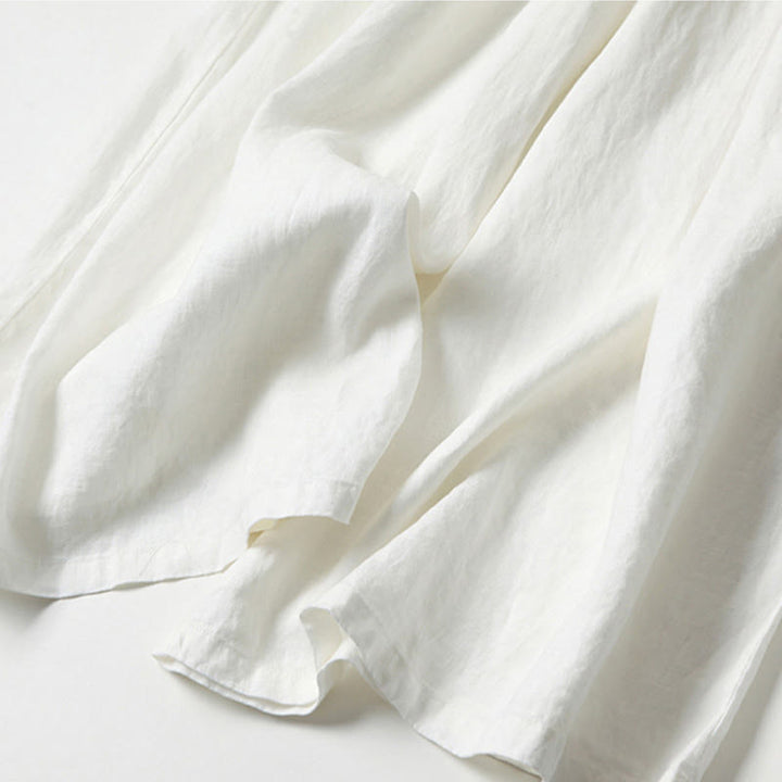 White women's high-waisted wide-leg trousers, relaxed fit for comfortable & chic everyday fashion.